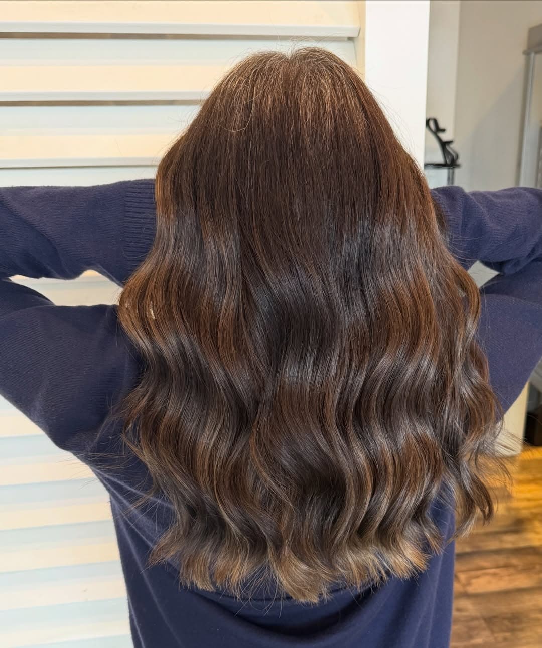 Glossy rich brunette waves colored and styled by Courtney Morgan